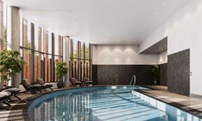 Ottawa apartment for rent - A large indoor swimming pool with lounge chairs and a sunken seating area.