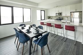 Ottawa apartment for rent - a dining room and kitchen with a table and chairs