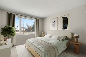 London apartment for rent - A bedroom with a large bed and a view of the outdoors through the window.