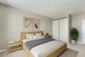 London apartment for rent - A bedroom with a bed, nightstand, and two framed pictures on the wall.
