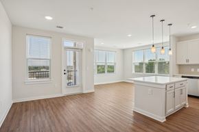 Concord apartment for rent - A kitchen with white cabinets and a wooden floor.