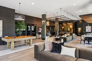 Concord apartment for rent - A modern living room with a pool table and comfortable seating.