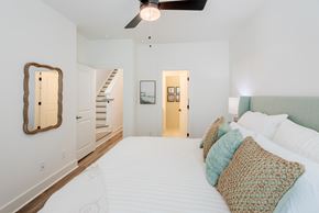 Charlotte townhouse for rent - A bedroom with a large bed and a ceiling fan.