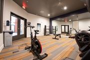 Rock Hill apartment for rent - 2200 sq ft gym with cardio machines and weights on a wood floor