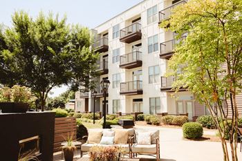 A courtyard with a couch and chairs