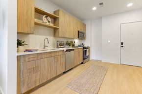 Spartanburg apartment for rent - A kitchen with wooden cabinets and a white countertop.