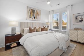 Spartanburg apartment for rent - A bedroom with a large bed and a painting on the wall.