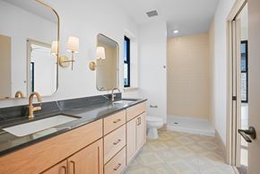 Charlotte townhouse for rent - A bathroom with a sink, mirror, and toilet.