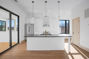 Charlotte townhouse for rent - A modern kitchen with a large island and stainless steel appliances.