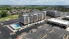 Concord apartment for rent - A large building with a pool in the parking lot.