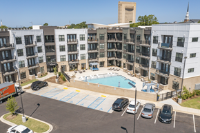 Spartanburg apartment for rent - an aerial view of a large swimming pool in front of an apartment building at The Fitzgerald, Spartanburg