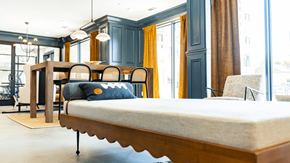Spartanburg apartment for rent - a large bed in a room with a table and chairs at The Fitzgerald, Spartanburg, South Carolina