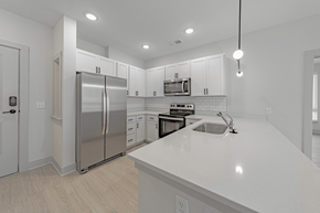Spartanburg apartment for rent - a kitchen with white cabinets and a white counter top at The Fitzgerald, Spartanburg