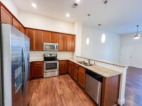Charlotte apartment for rent - a kitchen with wooden cabinets and stainless steel appliances