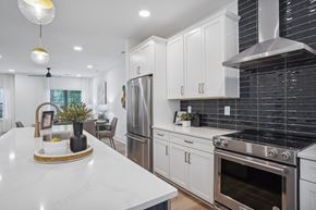 Charlotte apartment for rent - A modern kitchen with white cabinets and stainless steel appliances.