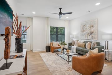Charlotte apartment for rent - A living room with a brown chair and a green couch.