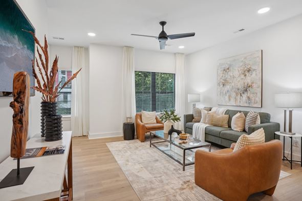 Charlotte apartment for rent - A living room with a brown leather chair and a green couch.