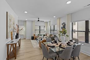 Charlotte townhouse for rent - A modern dining room with a glass table and grey chairs.