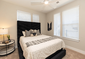 Hickory apartment for rent - A bedroom with a large bed and a ceiling fan.