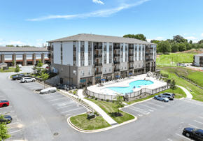 Hickory apartment for rent - A large apartment complex with a pool in the middle of the parking lot.