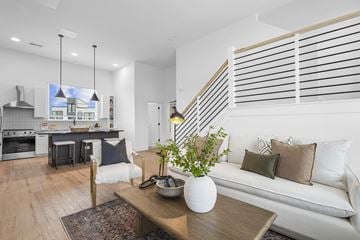 Charlotte townhouse for rent - A modern living room with a white couch and a wooden coffee table.