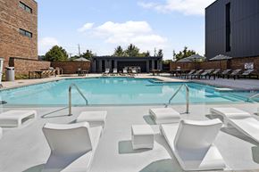 Spartanburg apartment for rent - A pool with white chairs around it.