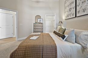 Cornelius apartment for rent - A bedroom with a bed, nightstand, and a dresser with a mirror.
