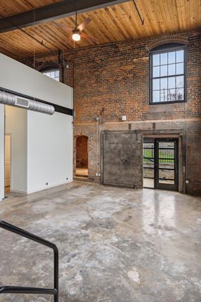 Lenoir apartment for rent - an empty room with a brick wall and a metal door