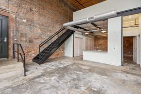Lenoir apartment for rent - the lobby of a building with a staircase and a brick wall