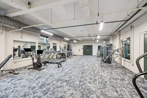 Lenoir apartment for rent - a workout room with weights and cardio equipment in a building