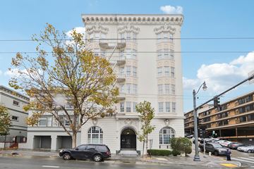 San Francisco apartment for rent - A large white building with a black car parked in front.
