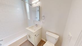San Francisco apartment for rent - A white bathroom with a toilet, sink, and tub.