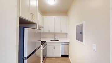San Francisco apartment for rent - A kitchen with white cabinets and appliances.
