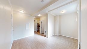 San Francisco apartment for rent - A spacious room with wooden flooring and white walls.