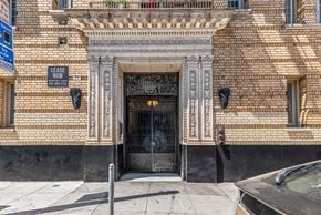 San Francisco apartment for rent - A building with a black door and a sign that says "LEASE NOW".