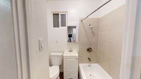 San Francisco apartment for rent - A white bathroom with a toilet, sink, and shower.