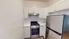 San Francisco apartment for rent - A kitchen with white cabinets and stainless steel appliances.