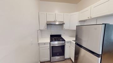 San Francisco apartment for rent - A kitchen with white cabinets and stainless steel appliances.