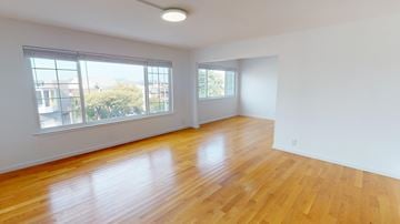 San Francisco apartment for rent - A room with wooden floors and white walls.