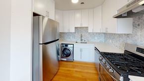 San Francisco apartment for rent - A kitchen with a stainless steel refrigerator and a black stove top.