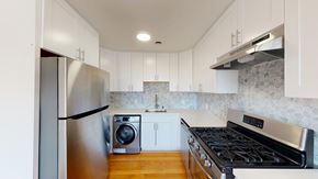 San Francisco apartment for rent - A modern kitchen with a stainless steel refrigerator and a stove top oven.