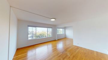 San Francisco apartment for rent - A room with wooden floors and white walls.