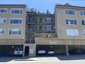 San Francisco apartment for rent - A building with a balcony and a parking garage.