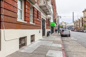 San Francisco apartment for rent - A street view with a car parked on the side of the road.