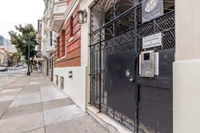 San Francisco apartment for rent - A black wrought iron gate blocks the entrance to a building.