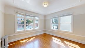 San Francisco apartment for rent - A sunny room with wooden floors and windows.