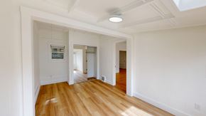 San Francisco apartment for rent - A long hallway with wood floors and white walls.