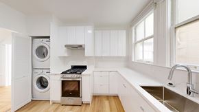San Francisco apartment for rent - A modern kitchen with a washing machine and dryer built into the cabinetry.