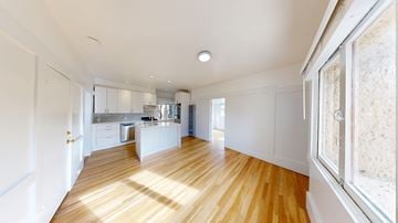San Francisco apartment for rent - A kitchen with white cabinets and a wooden floor.