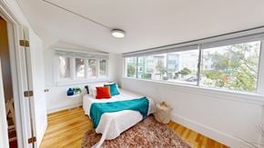 San Francisco apartment for rent - A bedroom with a bed, pillows, and a rug.